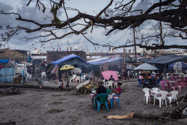 Resident gather on the Toamasina waterfront on February 14, 2026 days after the passage of tropical cyclone Gezani which destroyed a large part of the city during the night of February 10, 2026. (Photo by RIJASOLO / AFP)