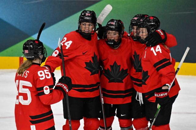 Canada's #29 Marie-Philip Poulin (3L) celebrates with teammates after scoring her team's fifth goal during the women's quarter final ice hockey match between Canada and Germany at the Milano Rho Ice Hockey Arena at the Milano Cortina 2026 Winter Olympic Games in Milan, on February 14, 2026. (Photo by Alexander NEMENOV / AFP)