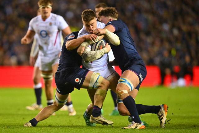 England's centre Tommy Freeman is tackled during the Six Nations international rugby union match between Scotland and England at Murrayfield Stadium in Edinburgh, Scotland on February 14, 2026. (Photo by ANDY BUCHANAN / AFP)