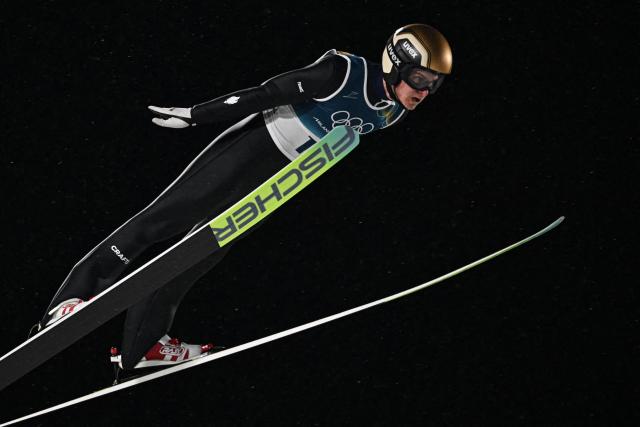 France's Enzo Milesi jumps during the 1st round of the men's large hill individual ski jumping of the Milano Cortina 2026 Winter Olympic Games at Predazzo Ski Jumping Stadium in Predazzo (Val di Fiemme), on February 14, 2026. (Photo by Javier SORIANO / AFP)