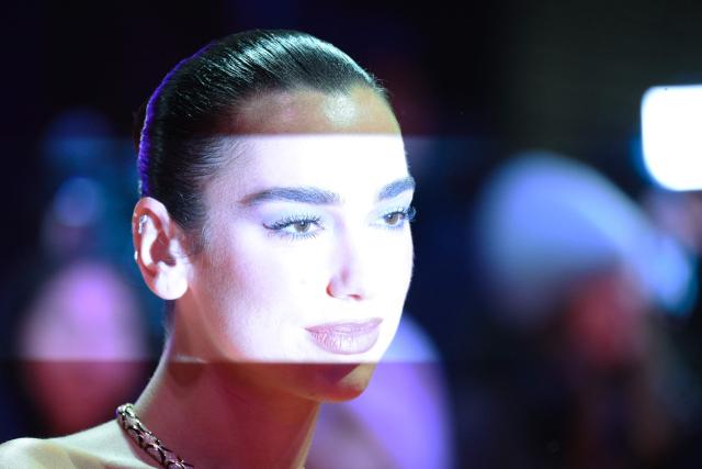 English singer and songwritter Dua Lipa poses on the red carpet for the premiere of the film "Rosebush Pruning" presented in competition at the 76th Berlinale, Europe's first major film festival of the year, in Berlin on February 14, 2026. (Photo by RALF HIRSCHBERGER / AFP)