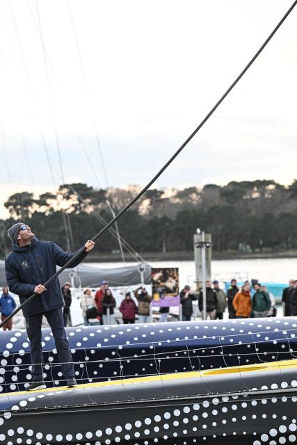 French skipper Charles Caudrelier pulls a rope aboard  the new multihull Gitana 18 Edmond de Rothschild after its inaugration on February 14, 2026, in Lorient, western France. (Photo by Sebastien Salom-Gomis / AFP)
