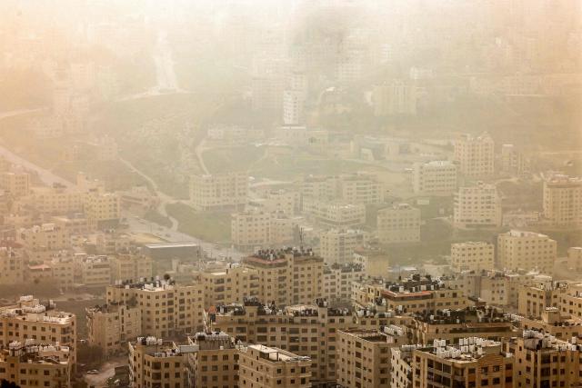 A dust storm engulfs the city of Nablus in the occupied West Bank on February 14, 2026. (Photo by Zain JAAFAR / AFP)