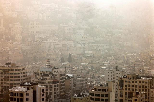 A dust storm engulfs the city of Nablus in the occupied West Bank on February 14, 2026. (Photo by Zain JAAFAR / AFP)