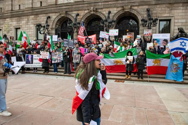 Protestors call for regime change in Iran, US intervention and for the end of the Islamic Republic at a rally in Copley Square in Boston, Massachusetts, on February 14, 2026. The protest comes after the bloody crackdown on protesters last month, while US President Donald Trump has been massing warships in the Middle East and declared Friday that a change of government in Iran would be the "best thing that could happen". (Photo by Joseph Prezioso / AFP)