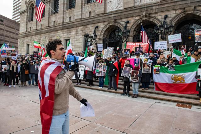 Protestors call for regime change in Iran, US intervention and for the end of the Islamic Republic at a rally in Copley Square in Boston, Massachusetts, on February 14, 2026. The protest comes after the bloody crackdown on protesters last month, while US President Donald Trump has been massing warships in the Middle East and declared Friday that a change of government in Iran would be the "best thing that could happen". (Photo by Joseph Prezioso / AFP)