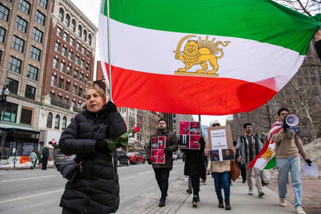 Protestors call for regime change in Iran, US intervention and for the end of the Islamic Republic at a rally in Copley Square in Boston, Massachusetts, on February 14, 2026. The protest comes after the bloody crackdown on protesters last month, while US President Donald Trump has been massing warships in the Middle East and declared Friday that a change of government in Iran would be the "best thing that could happen". (Photo by Joseph Prezioso / AFP)