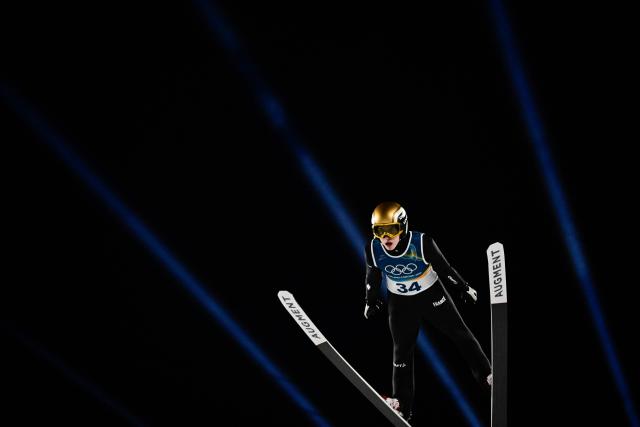 France's Valentin Foubert jumps during the final round of the men's large hill individual ski jumping of the Milano Cortina 2026 Winter Olympic Games at Predazzo Ski Jumping Stadium in Predazzo (Val di Fiemme), on February 14, 2026. (Photo by Tobias SCHWARZ / AFP)