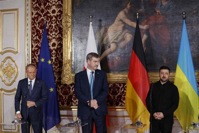 (From L) Polish Prime Minister Donald Tusk, Bavarian State Premier Markus Soeder and Ukrainian President Volodymyr Zelensky give a press statement at the Munich Residence palace, prior to the traditional dinner on the occasion of the Munich Security Conference (MSC), on February 14, 2026 in Munich, southern Germany. (Photo by Michaela STACHE / AFP)
