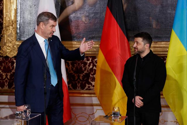 Bavarian State Premier Markus Soeder (L) and Ukrainian President Volodymyr Zelensky give a press statement at the Munich Residence palace, prior to the traditional dinner on the occasion of the Munich Security Conference (MSC), on February 14, 2026 in Munich, southern Germany. (Photo by Michaela STACHE / AFP)