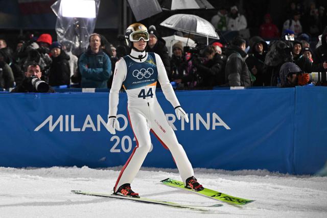 Austria's Jan Hoerl reacts in the finish area after jumping during the final round of the men's large hill individual ski jumping of the Milano Cortina 2026 Winter Olympic Games at Predazzo Ski Jumping Stadium in Predazzo (Val di Fiemme), on February 14, 2026. (Photo by Javier SORIANO / AFP)