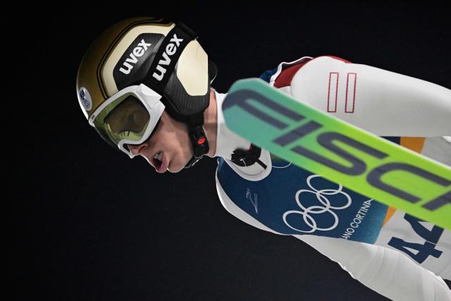 Austria's Jan Hoerl jumps during the final round of the men's large hill individual ski jumping of the Milano Cortina 2026 Winter Olympic Games at Predazzo Ski Jumping Stadium in Predazzo (Val di Fiemme), on February 14, 2026. (Photo by Tobias SCHWARZ / AFP)