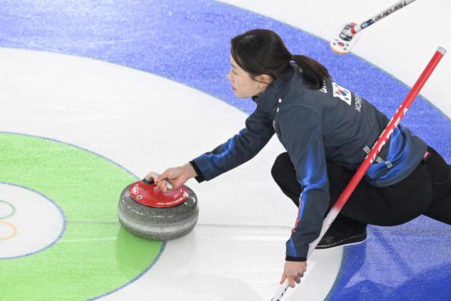 South Korea's Gim Eun-ji delivers the stone during  the curling women's round robin between South Korea and Denmark during the Milano Cortina 2026 Winter Olympic Games at the Cortina Curling Olympic Stadium in Cortina d’Ampezzo on February 14, 2026. (Photo by Tiziana FABI / AFP)