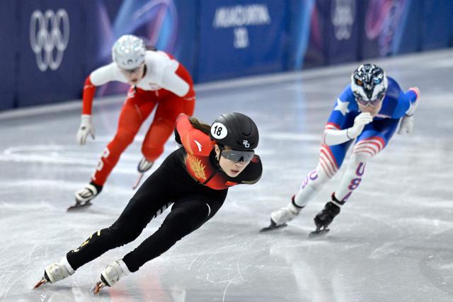 China's Gong Li leads in the short track speed skating women's 1000m heats during the Milano Cortina 2026 Winter Olympic Games at Milano Ice Skating Arena in Milan on February 14, 2026. (Photo by WANG Zhao / AFP)