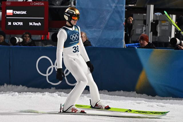 Poland's Kacper Tomasiak reacts in the finish area after jumping during the final round of the men's large hill individual ski jumping of the Milano Cortina 2026 Winter Olympic Games at Predazzo Ski Jumping Stadium in Predazzo (Val di Fiemme), on February 14, 2026. (Photo by Javier SORIANO / AFP)