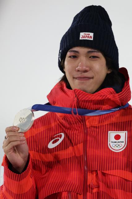 Silver medallist Japan's Ren Nikaido celebrates on the podium of the men's large hill individual ski jumping of the Milano Cortina 2026 Winter Olympic Games at Predazzo Ski Jumping Stadium in Predazzo (Val di Fiemme), on February 14, 2026. (Photo by Anne-Christine POUJOULAT / AFP)
