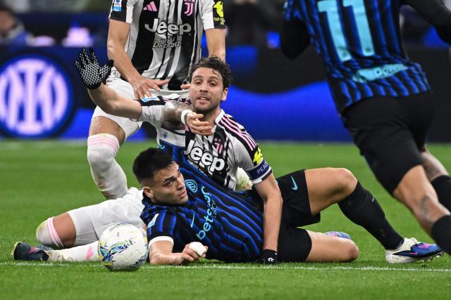 Juventus' Italian midfielder #5 Manuel Locatelli and Inter Milan's Romanian coach Cristian Chivu fight for the ball during the Italian Serie A football match between Inter Milan and Juventus at the San Siro Stadium in Milan, on February 14, 2026. (Photo by Piero CRUCIATTI / AFP)