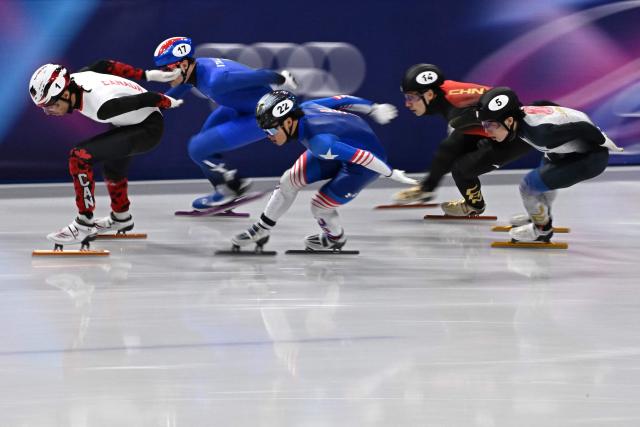 (L-R) Canada's William Dandjinou, Italy's Luca Spechenhauser, USA's Andrew Heo, China's Liu Shaoang and Japan's Shogo Miyata compete in the short track speed skating men's 1500m semi-final during the Milano Cortina 2026 Winter Olympic Games at Milano Ice Skating Arena in Milan on February 14, 2026. (Photo by Gabriel BOUYS / AFP)