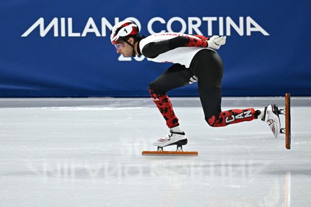 Canada's William Dandjinou competes in the short track speed skating men's 1500m semi-final during the Milano Cortina 2026 Winter Olympic Games at Milano Ice Skating Arena in Milan on February 14, 2026. (Photo by Gabriel BOUYS / AFP)