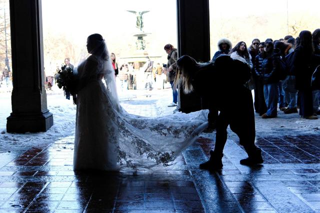 A bride gets ready for a photoshoot in Central Park on Valentine’s day in New York on February 14, 2026. (Photo by Charly TRIBALLEAU / AFP)