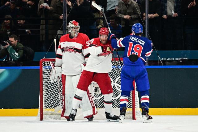 Denmark's #48 Nicholas B Jensen (C) and USA's #19 Matthew Tkachuk have an altercation during the men's preliminary round Group C Ice Hockey match between USA and Denmark at the Milano Santagiulia Ice Hockey Arena during the Milano Cortina 2026 Winter Olympic Games in Milan, on February 14, 2026. (Photo by JULIEN DE ROSA / AFP)