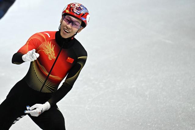 China's Sun Long reacts after competing in the short track speed skating men's 1500m semi-final during the Milano Cortina 2026 Winter Olympic Games at Milano Ice Skating Arena in Milan on February 14, 2026. (Photo by Gabriel BOUYS / AFP)