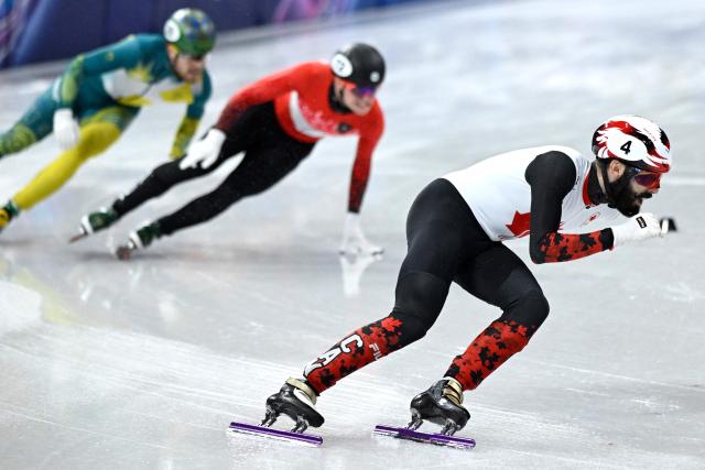 Canada's Steven Dubois leads in the short track speed skating men's 1500m semi-final during the Milano Cortina 2026 Winter Olympic Games at Milano Ice Skating Arena in Milan on February 14, 2026. (Photo by WANG Zhao / AFP)