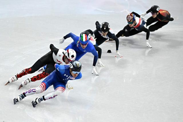 (L-R) USA's Andrew Heo, Canada's William Dandjinou, Italy's Luca Spechenhauser, Japan's Shogo Miyata, Japan's Keita Watanabe, South Korea's Hwang Dae-heon and China's Liu Shaoang compete in the short track speed skating men's 1500m semi-final during the Milano Cortina 2026 Winter Olympic Games at Milano Ice Skating Arena in Milan on February 14, 2026. (Photo by Gabriel BOUYS / AFP)