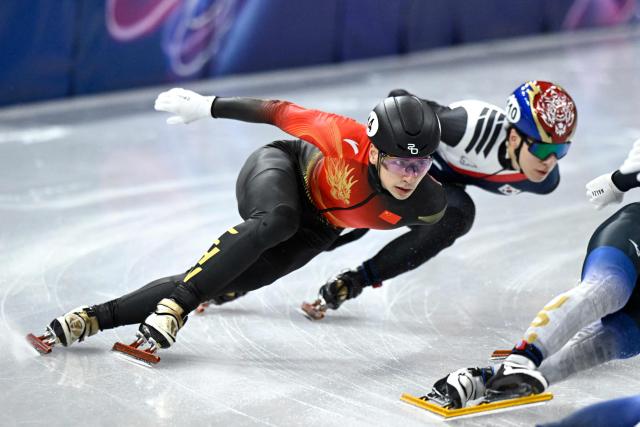 China's Liu Shaoang (L) and South Korea's Hwang Dae-heon compete in the short track speed skating men's 1500m semi-final during the Milano Cortina 2026 Winter Olympic Games at Milano Ice Skating Arena in Milan on February 14, 2026. (Photo by WANG Zhao / AFP)