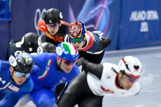 China's Liu Shaoang (top L) and South Korea's Hwang Dae-heon compete in the short track speed skating men's 1500m semi-final during the Milano Cortina 2026 Winter Olympic Games at Milano Ice Skating Arena in Milan on February 14, 2026. (Photo by WANG Zhao / AFP)
