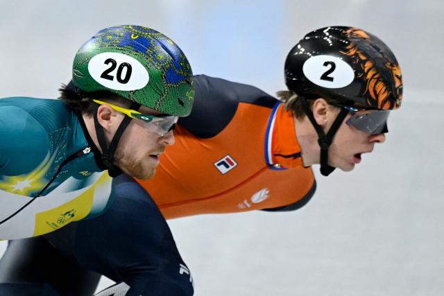 Australia's Brendan Corey (L) and Netherlands' Jens van 't Wout compete in the short track speed skating men's 1500m semi-final during the Milano Cortina 2026 Winter Olympic Games at Milano Ice Skating Arena in Milan on February 14, 2026. (Photo by WANG Zhao / AFP)