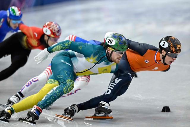 (R-L) Netherlands' Jens van 't Wout and Australia's Brendan Corey compete in the short track speed skating men's 1500m semi-final during the Milano Cortina 2026 Winter Olympic Games at Milano Ice Skating Arena in Milan on February 14, 2026. (Photo by WANG Zhao / AFP)