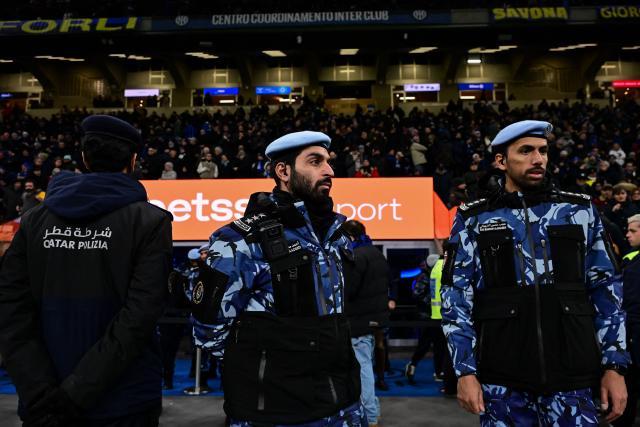 Qatari police officers stand guard during the Italian Serie A football match between Inter Milan and Juventus at the San Siro Stadium in Milan, on February 14, 2026. (Photo by Piero CRUCIATTI / AFP)