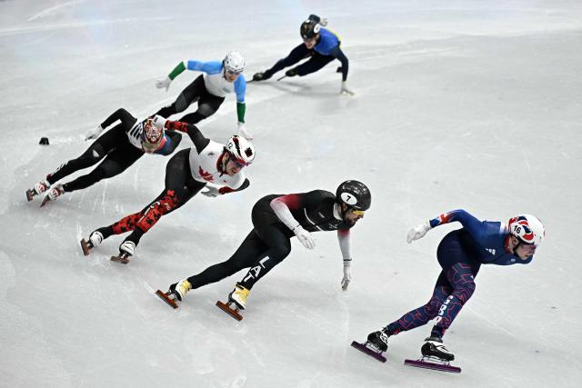 (R-L) Britain's Niall Treacy, Latvia's Roberts Kruzbergs and Canada's Felix Roussel compete in the short track speed skating men's 1500m semi-final during the Milano Cortina 2026 Winter Olympic Games at Milano Ice Skating Arena in Milan on February 14, 2026. (Photo by Gabriel BOUYS / AFP)
