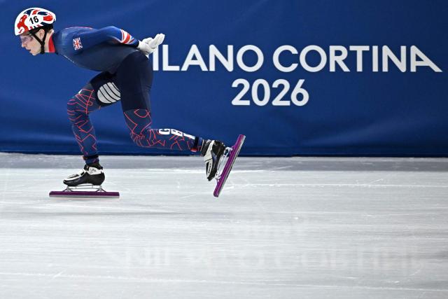 Britain's Niall Treacy competes in the short track speed skating men's 1500m semi-final during the Milano Cortina 2026 Winter Olympic Games at Milano Ice Skating Arena in Milan on February 14, 2026. (Photo by Gabriel BOUYS / AFP)