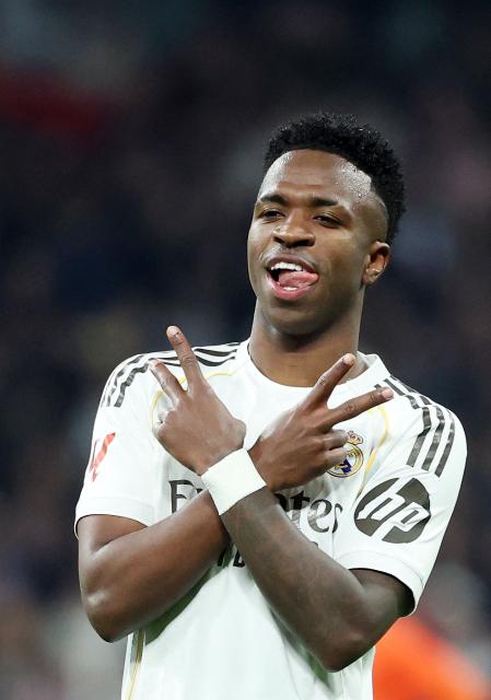 TOPSHOT - Real Madrid's Brazilian forward #07 Vinicius Junior celebrates scoring his team's fourth goal during the Spanish league football match between Real Madrid CF and Real Sociedad at Santiago Bernabeu Stadium in Madrid on February 14, 2026. (Photo by Pierre-Philippe MARCOU / AFP)