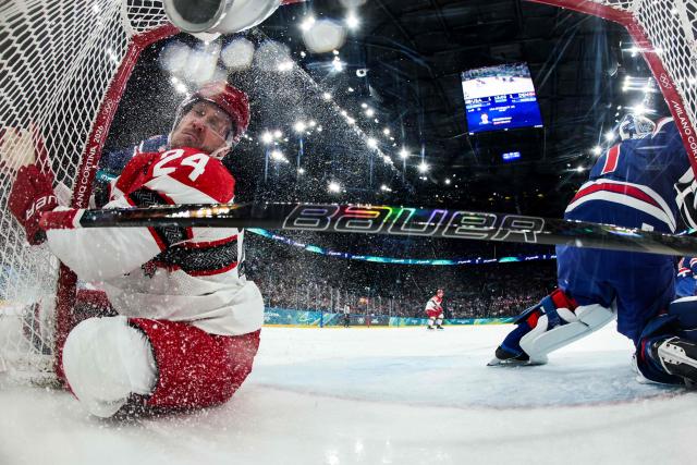 Denmark's #24 Nikolaj Ehlers crashes on the goal during the men's preliminary round Group C Ice Hockey match between USA and Denmark at the Milano Santagiulia Ice Hockey Arena during the Milano Cortina 2026 Winter Olympic Games in Milan, on February 14, 2026. (Photo by POOL / AFP)