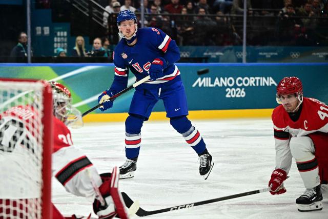 USA's #09 Jack Eichel (C) makes an attempt on goal during the men's preliminary round Group C Ice Hockey match between USA and Denmark at the Milano Santagiulia Ice Hockey Arena during the Milano Cortina 2026 Winter Olympic Games in Milan, on February 14, 2026. (Photo by JULIEN DE ROSA / AFP)