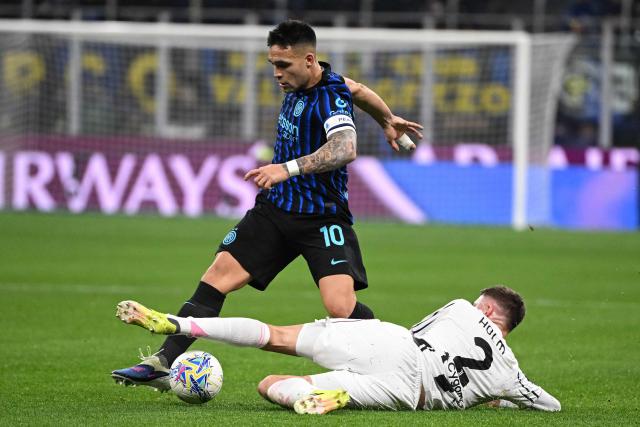 Inter Milan's Argentinian forward #10 Lautaro Martinez (L) is tackled by Juventus' Swedish defender #02 Emil Holm (R) during the Italian Serie A football match between Inter Milan and Juventus at the San Siro Stadium in Milan, on February 14, 2026. (Photo by Piero CRUCIATTI / AFP)