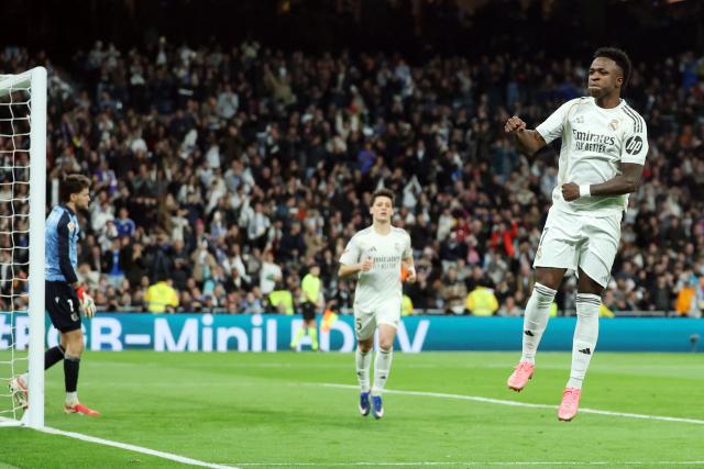 TOPSHOT - Real Madrid's Brazilian forward #07 Vinicius Junior celebrates scoring his team's fourth goal during the Spanish league football match between Real Madrid CF and Real Sociedad at Santiago Bernabeu Stadium in Madrid on February 14, 2026. (Photo by Pierre-Philippe MARCOU / AFP)