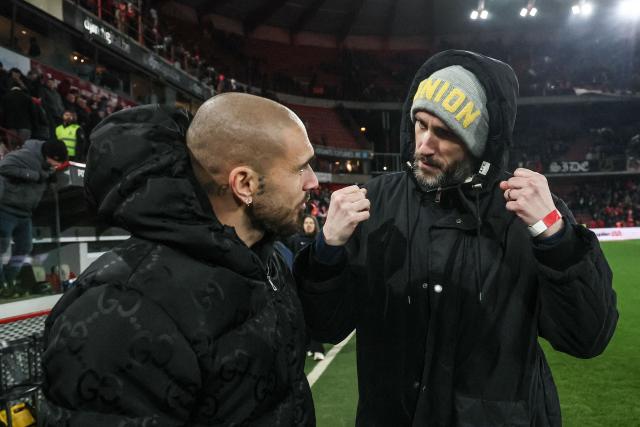 Former player Teddy Teuma and Union's chairman of the board Alex Muzio talk after after the Belgian "Pro League" First Division football match between Standard Liege and Royale Union Saint-Gilloise  at Stade Maurice Dufrasne in Liege on February 14, 2026. (Photo by BRUNO FAHY / BELGA / AFP) / Belgium OUT