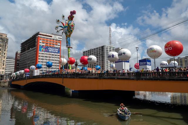 Revelers take part in the Galo da Madrugada (Dawn Rooster) carnival band parade on the streets of Recife, Brazil on February 14, 2026. (Photo by Carlos FABAL / AFP)