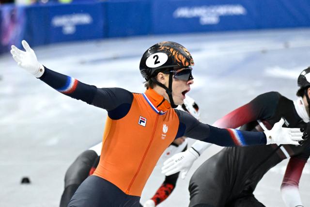 Netherlands' Jens van 't Wout celebrates as he crosses the finish line to win gold in the short track speed skating men's 1500m final during the Milano Cortina 2026 Winter Olympic Games at Milano Ice Skating Arena in Milan on February 14, 2026. (Photo by WANG Zhao / AFP)