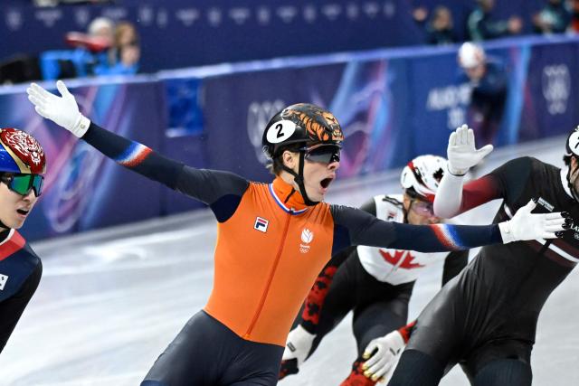 Netherlands' Jens van 't Wout celebrates as he crosses the finish line to win gold in the short track speed skating men's 1500m final during the Milano Cortina 2026 Winter Olympic Games at Milano Ice Skating Arena in Milan on February 14, 2026. (Photo by WANG Zhao / AFP)