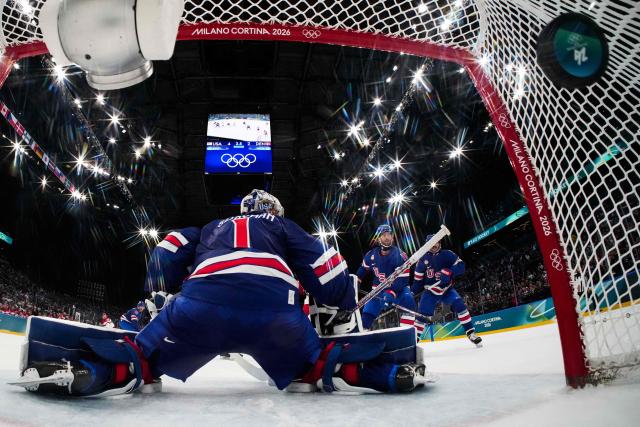 Denmark's #42 Phillip Bruggisser (not pictured) scores the 4-3 goal during the men's preliminary round Group C Ice Hockey match between USA and Denmark at the Milano Santagiulia Ice Hockey Arena during the Milano Cortina 2026 Winter Olympic Games in Milan, on February 14, 2026. (Photo by POOL / AFP)