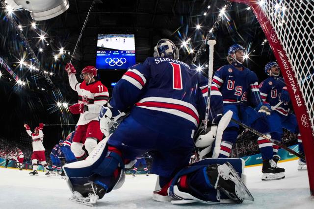 Denmark's #11 Alexander True (L) celebrates after the 4-3 goal scored by Denmark's #42 Phillip Bruggisser (not pictured) during the men's preliminary round Group C Ice Hockey match between USA and Denmark at the Milano Santagiulia Ice Hockey Arena during the Milano Cortina 2026 Winter Olympic Games in Milan, on February 14, 2026. (Photo by POOL / AFP)