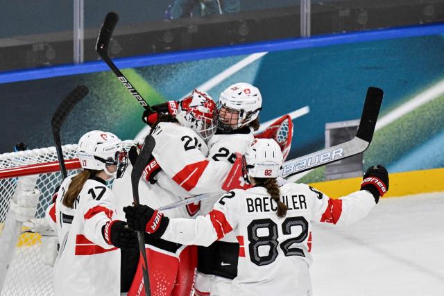 Switzerland's teammates celebrate after winning at the end of the women's quarter final ice hockey match between Finland and Switzerland at the Milano Rho Ice Hockey Arena at the Milano Cortina 2026 Winter Olympic Games in Milan, on February 14, 2026. Switzerland wins 1 - 0 against Finland and qualifies for the semi-finals. (Photo by Alexander NEMENOV / AFP)