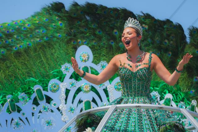 The Queen of the Barranquilla Carnival, Michelle Char, gestures during the Batalla de Flores (Battle of Flowers) carnival parade in Barranquilla, Colombia on February 14, 2026. (Photo by Vanessa ROMERO / AFP)