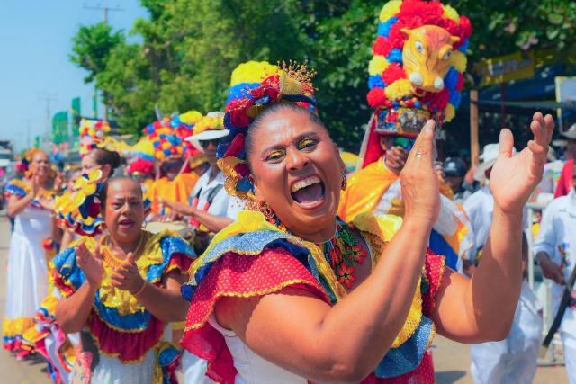 Revelers take part in the Batalla de Flores (Battle of Flowers) carnival parade in Barranquilla, Colombia on February 14, 2026. (Photo by Vanessa ROMERO / AFP)