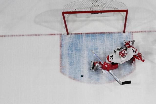 Switzerland's #20 Andrea Braendli makes a save during the women's quarter final ice hockey match between Finland and Switzerland at the Milano Rho Ice Hockey Arena at the Milano Cortina 2026 Winter Olympic Games in Milan, on February 14, 2026. (Photo by Alexander NEMENOV / AFP)